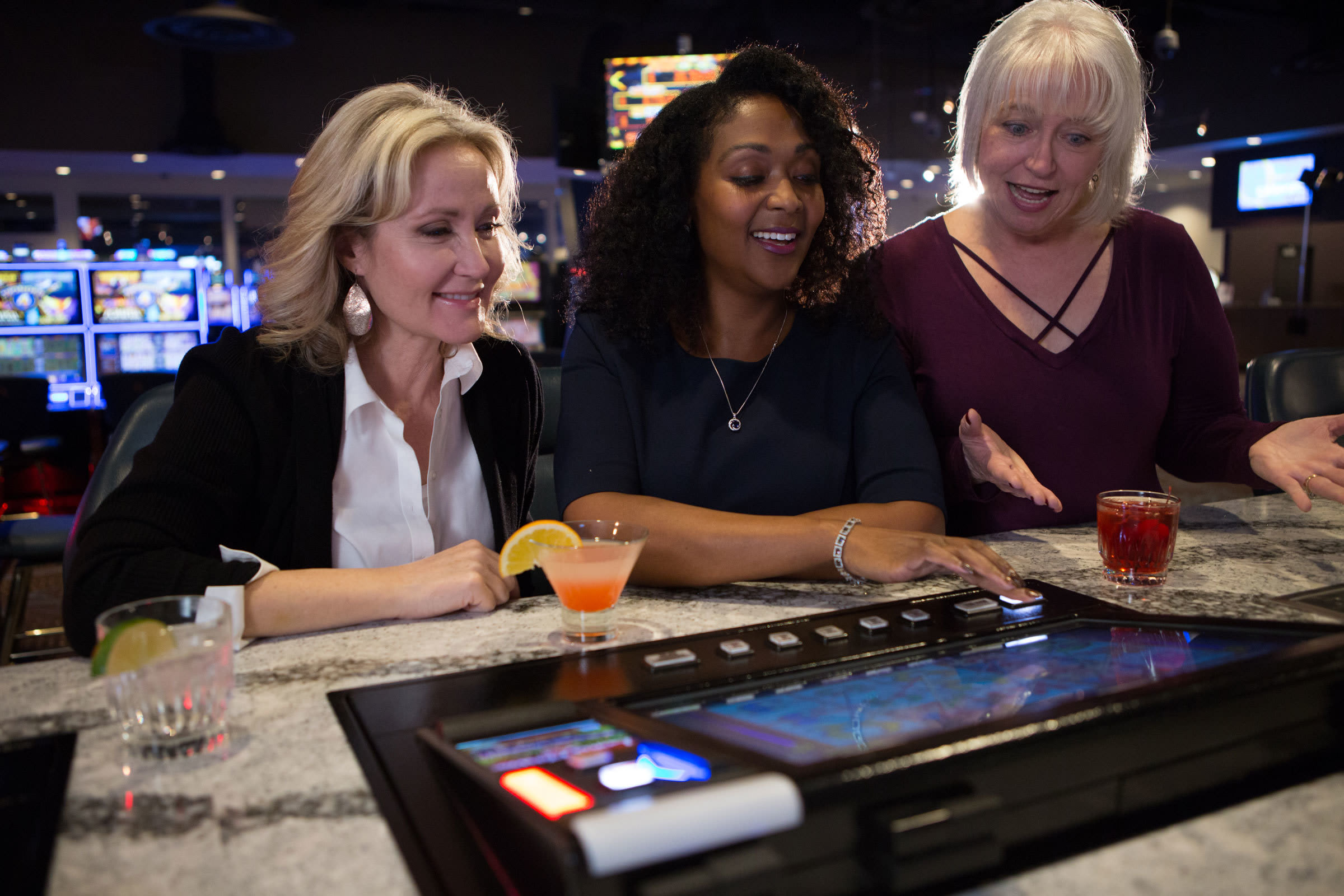 Three ladies sitting at the bar