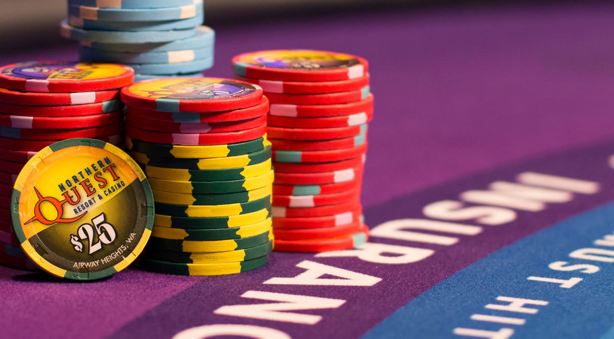 Promotional image of Northern Quest player chips stacked on a blackjack table.