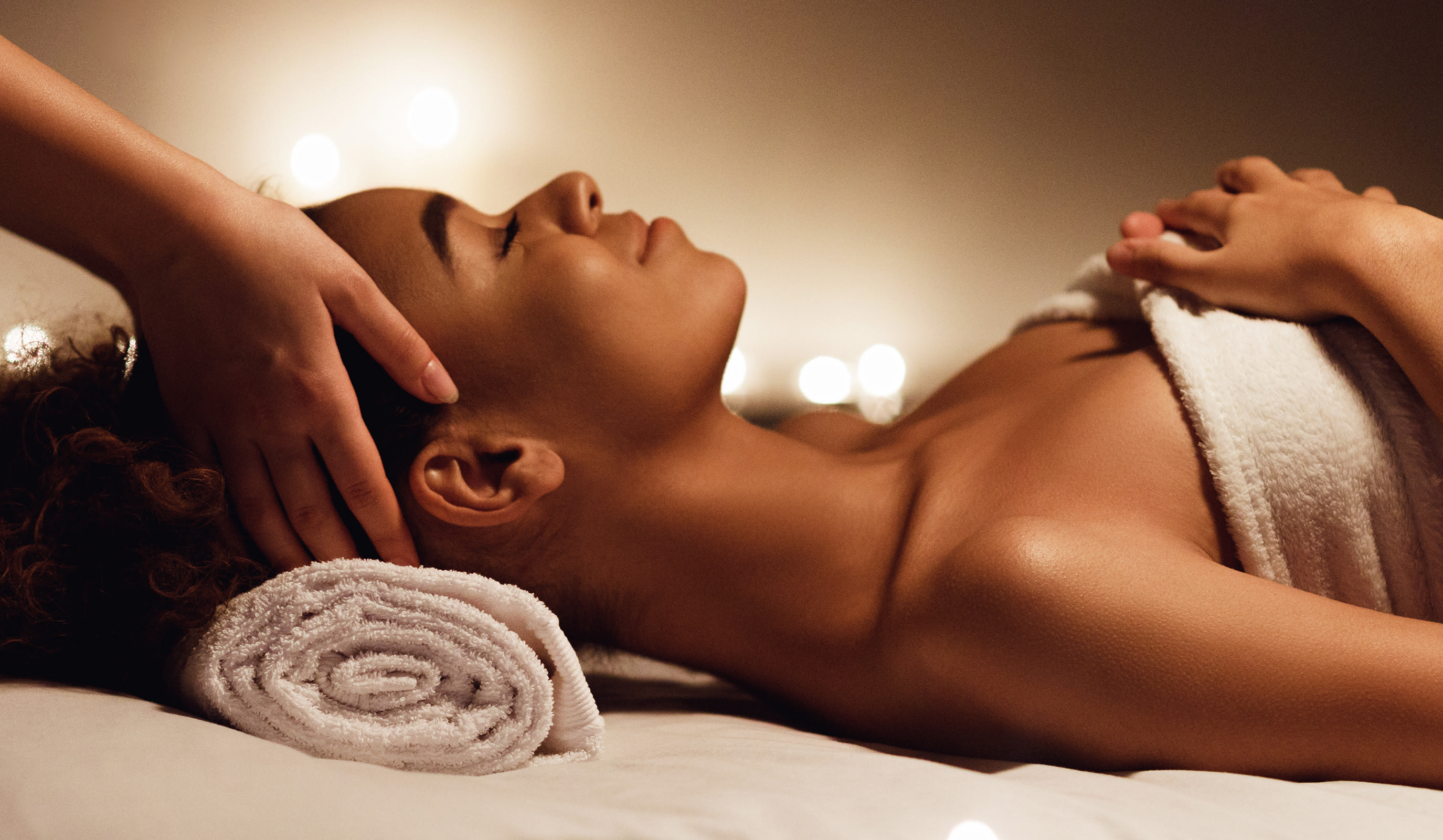 A woman with a rolled up towel resting under her head