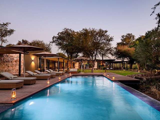 Tanda tula safari camp pool at the night