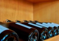 A closeup of wine bottles in a wooden shelf at a winery in mendoza argentina