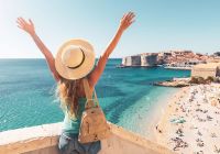 Happy woman tourist enjoying view of the old town of dubrovnik in croatia
