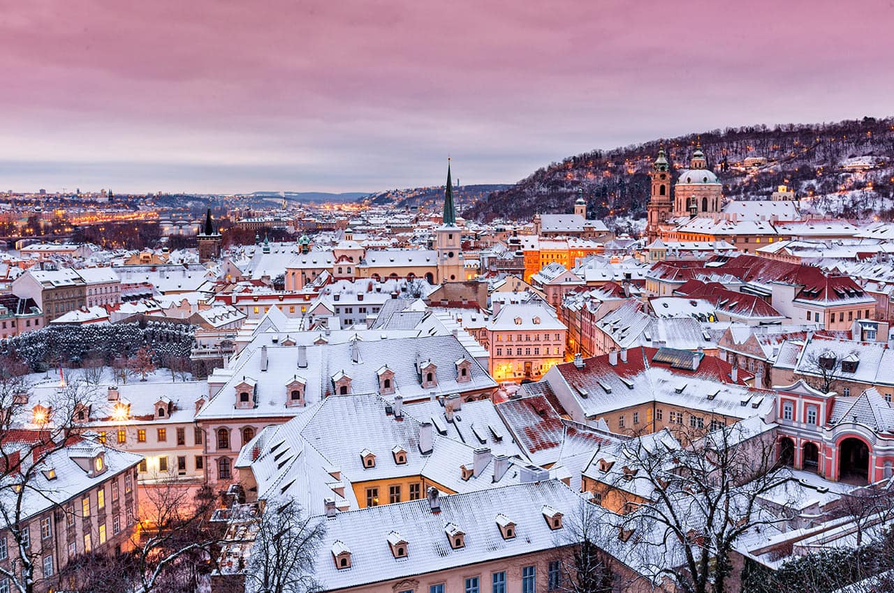 Prague in winter time view on snowy roofs with historical buildings