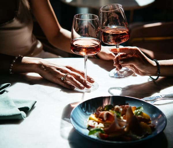 Glasses of rose wine seen during a friendly party or a celebration in a restaurant of a bar