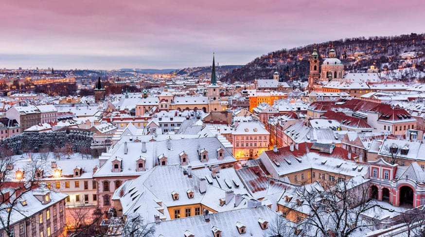 Prague in winter time view on snowy roofs with historical buildings