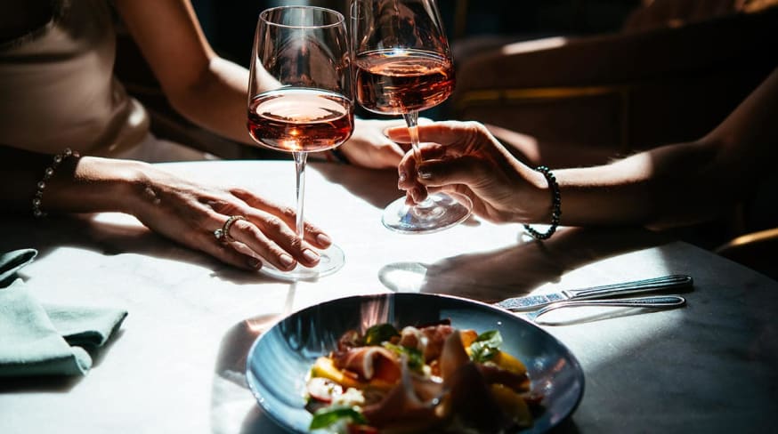 Glasses of rose wine seen during a friendly party or a celebration in a restaurant of a bar