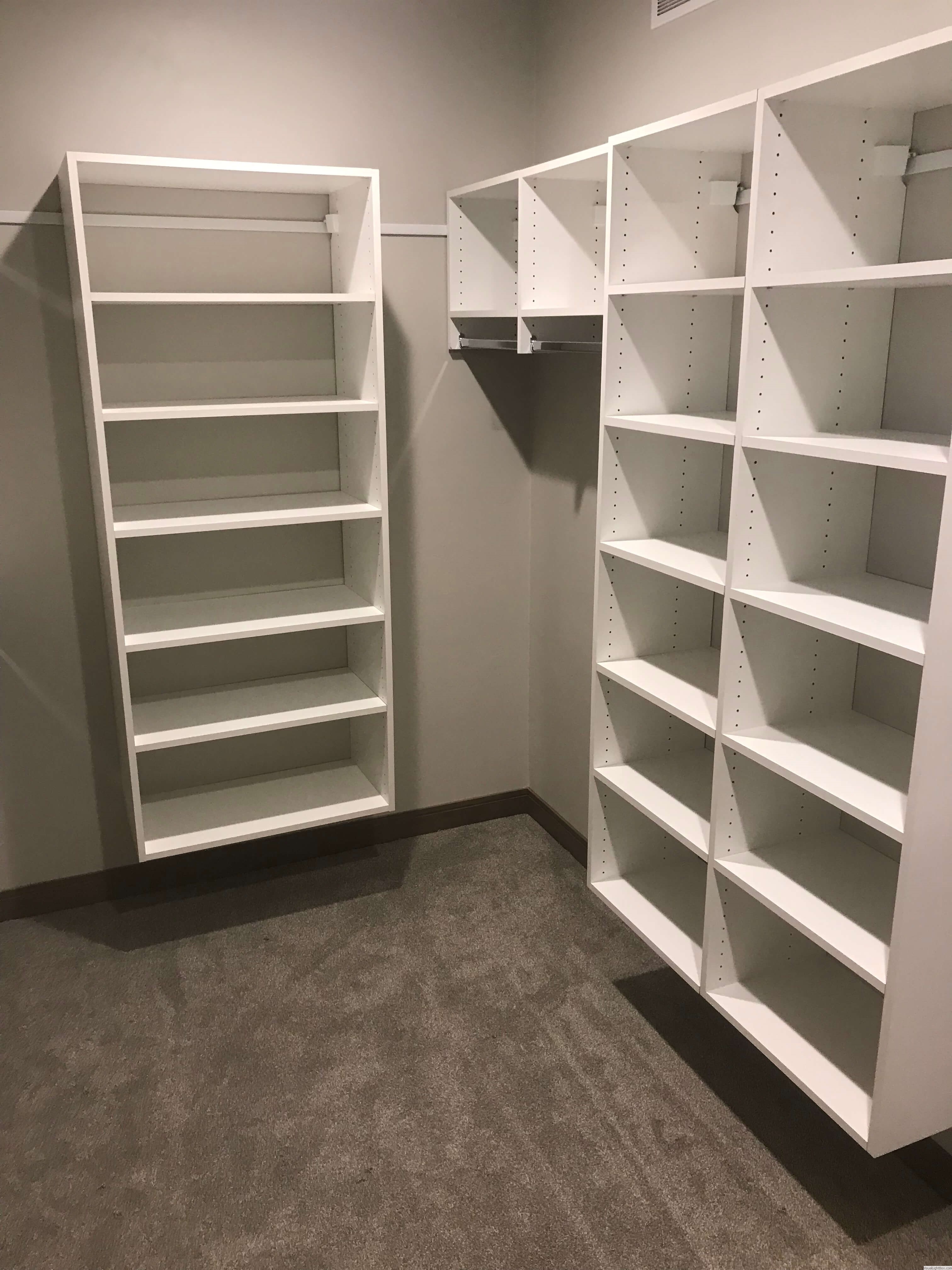 Custom closet with staggered white shelving and open hanging space in Green Bay, WI.