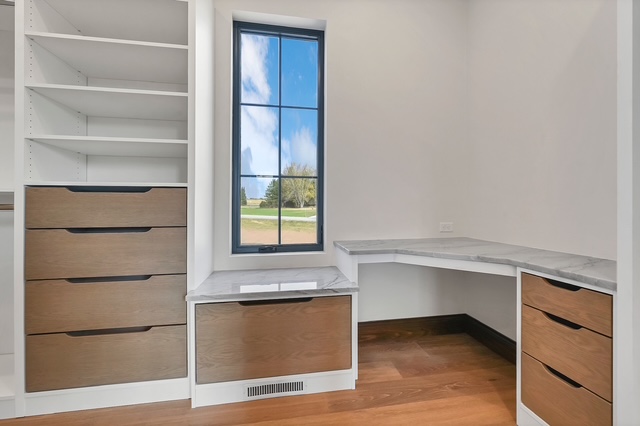 Custom built-in cabinetry with drawers and marble countertop in a home office in Green Bay, WI.