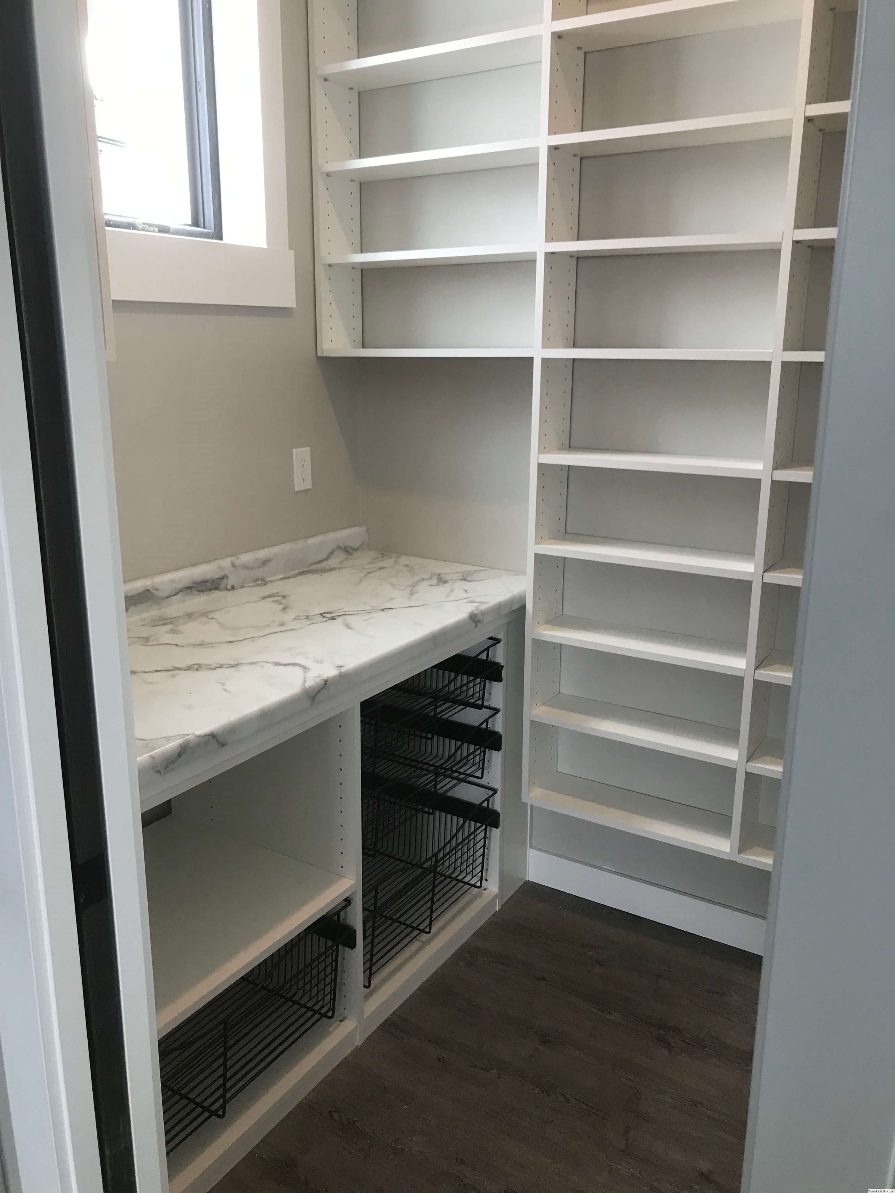 His and hers custom closet with built-in shelving, drawers, and pull-down hanging rods in Green Bay, WI.