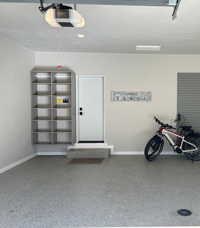 Modern garage with mounted bike storage and custom gray wall shelving in Green Bay.