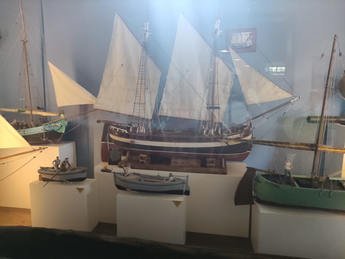 Rigged model sailing ships and fishing boats in a glass case in the Košljun monastery museum