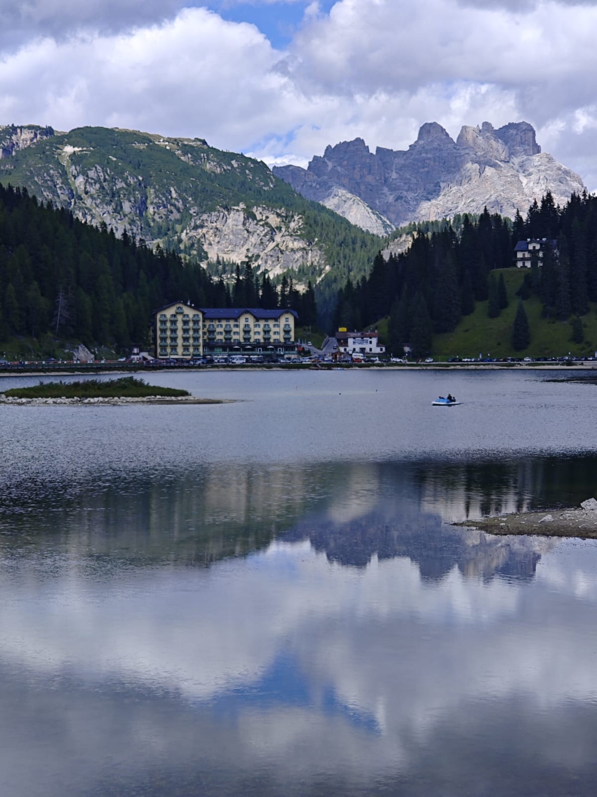 The lake at Misurina with a hotel on its far shore and the Cadini peaks reflected in the calm water
