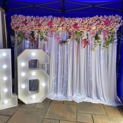 Light Up 16 And A Draped Flower Wall Backdrop For A 16th Birthday