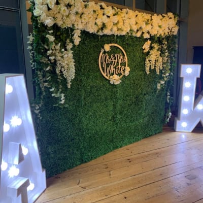 Grass Backdrop With Flowers And Led Light Up Letters And Personalised Hoop For A Wedding In Bexley By Deluxe Flower Walls