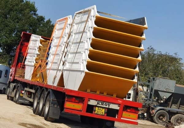 huge stack of skips on delivery truck