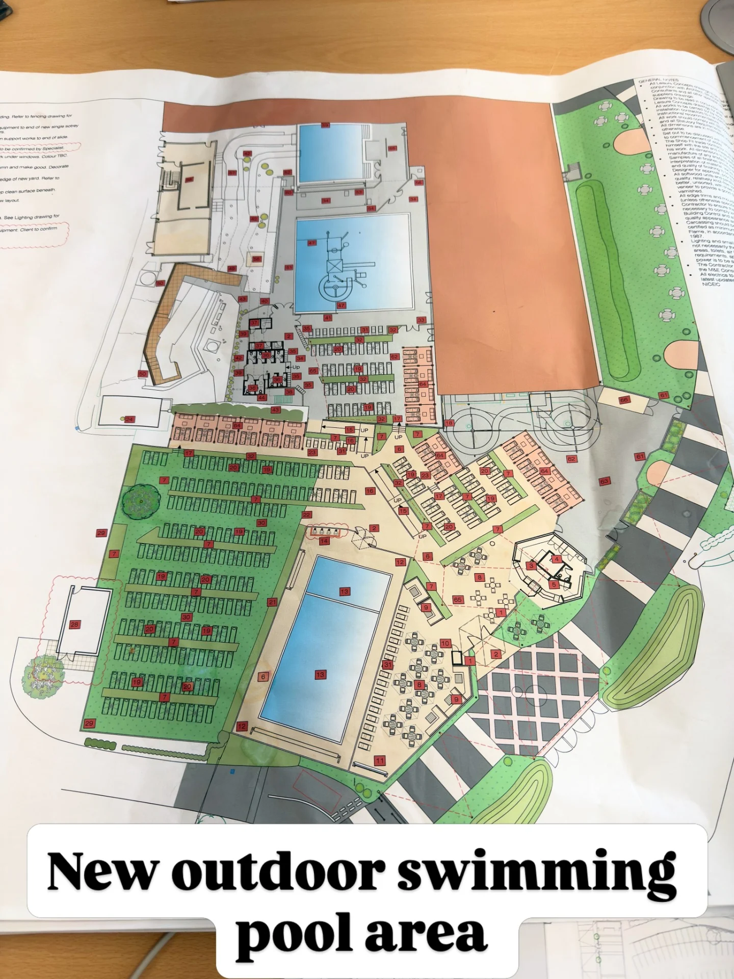 Architectural site plan showing a new outdoor swimming pool area with seating, landscaping, and pathways.