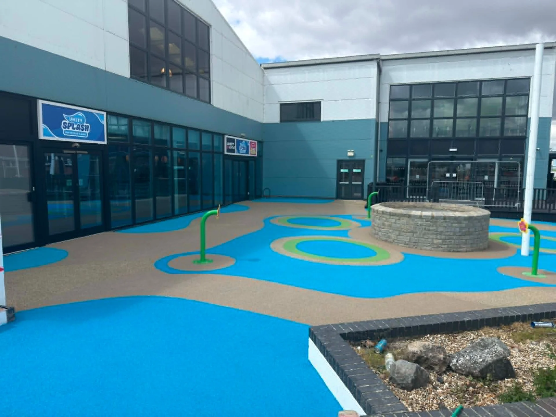 Custom swimming pool entrance flooring featuring bright resin designs, safe non-slip surfaces and long-lasting performance for commercial leisure facilities.