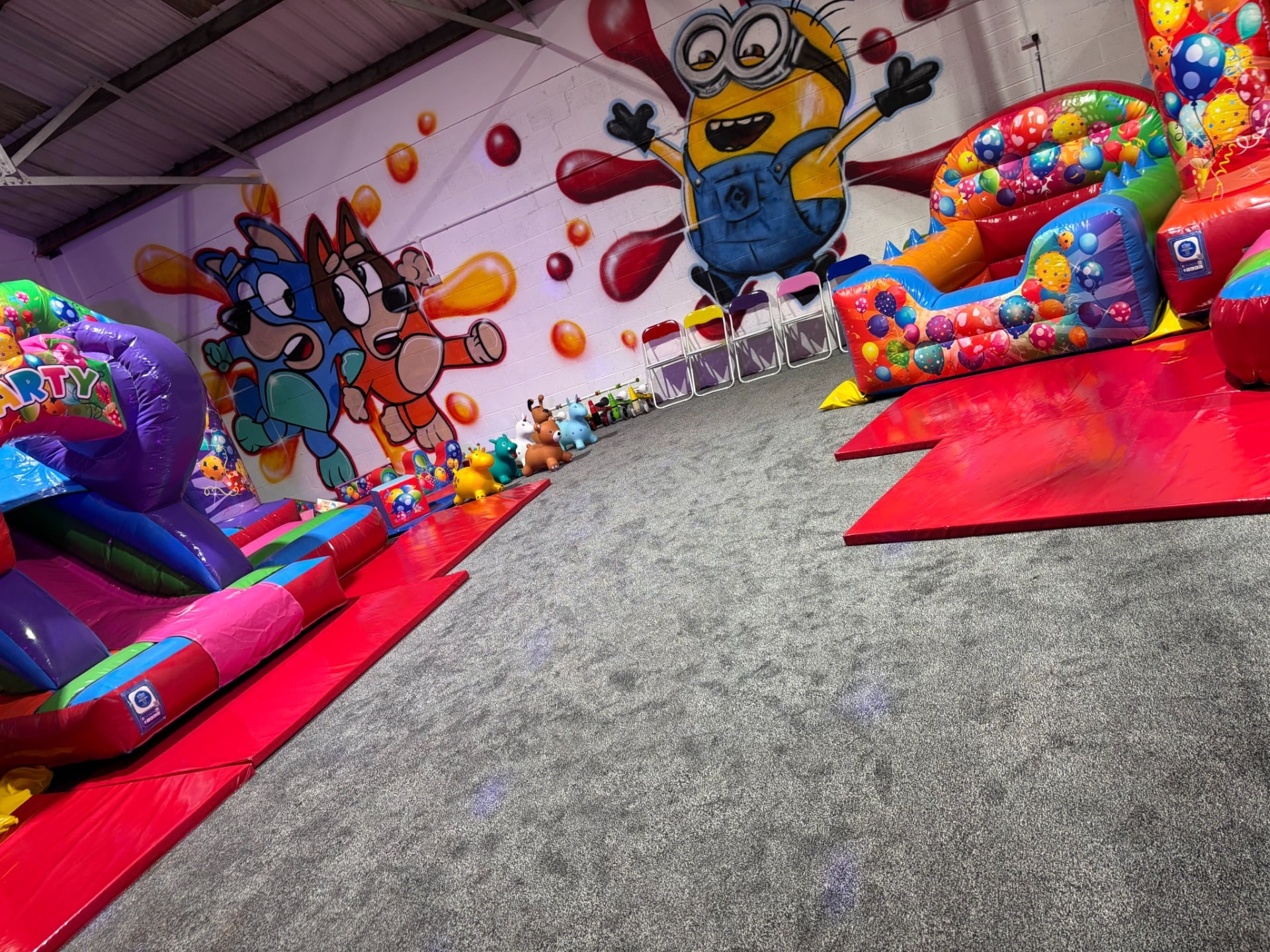 Multicoloured Party Theme Bouncy Castle and Inflatable Slide Multicoloured Party Theme Bouncy Castle and Inflatable Slide