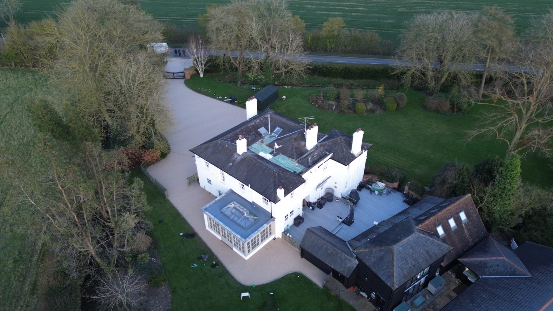 Aerial view of a large countryside home in essex with a resin bound driveway, landscaped gardens,.