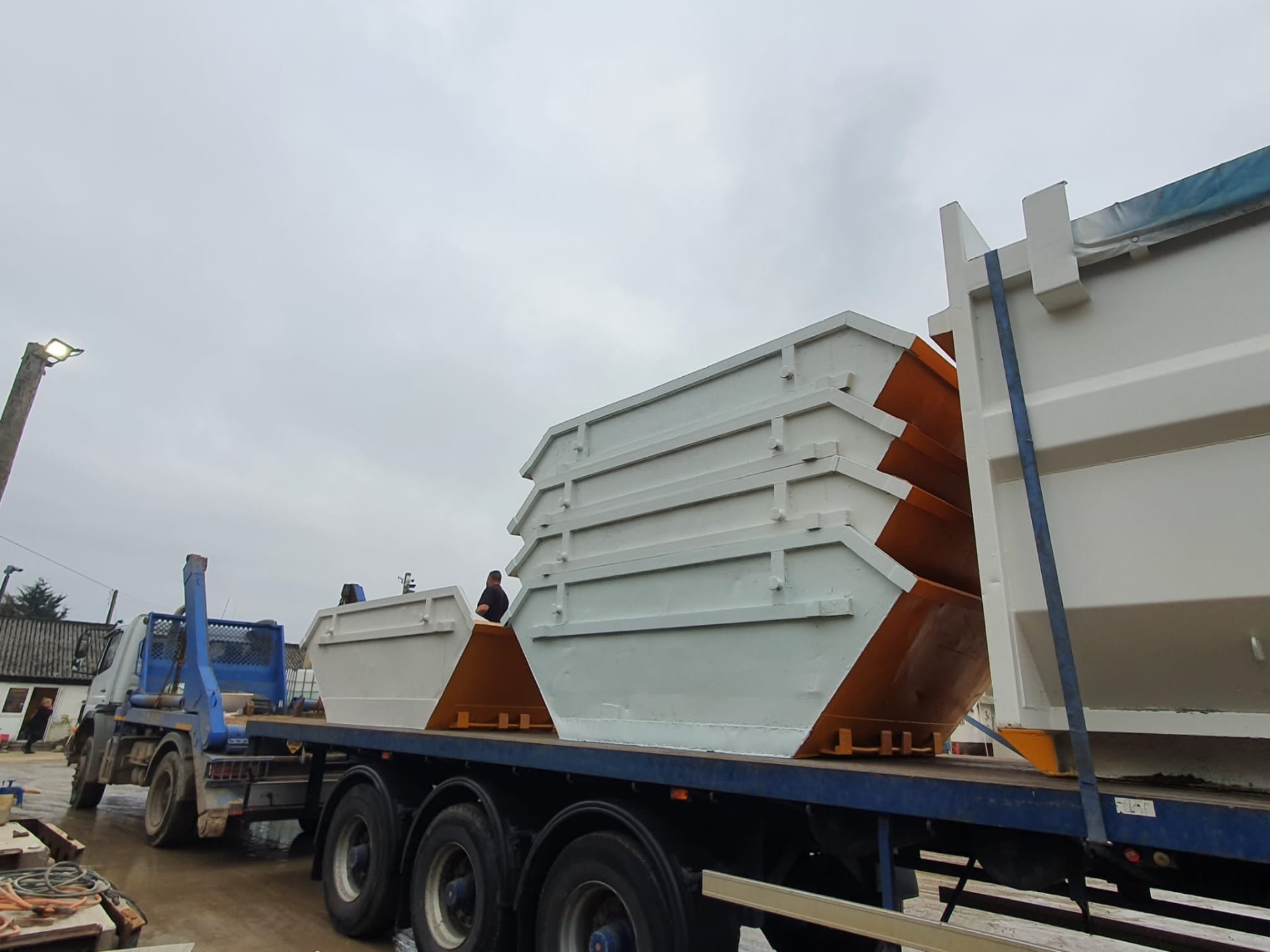 skip hire lorry with stacked skips