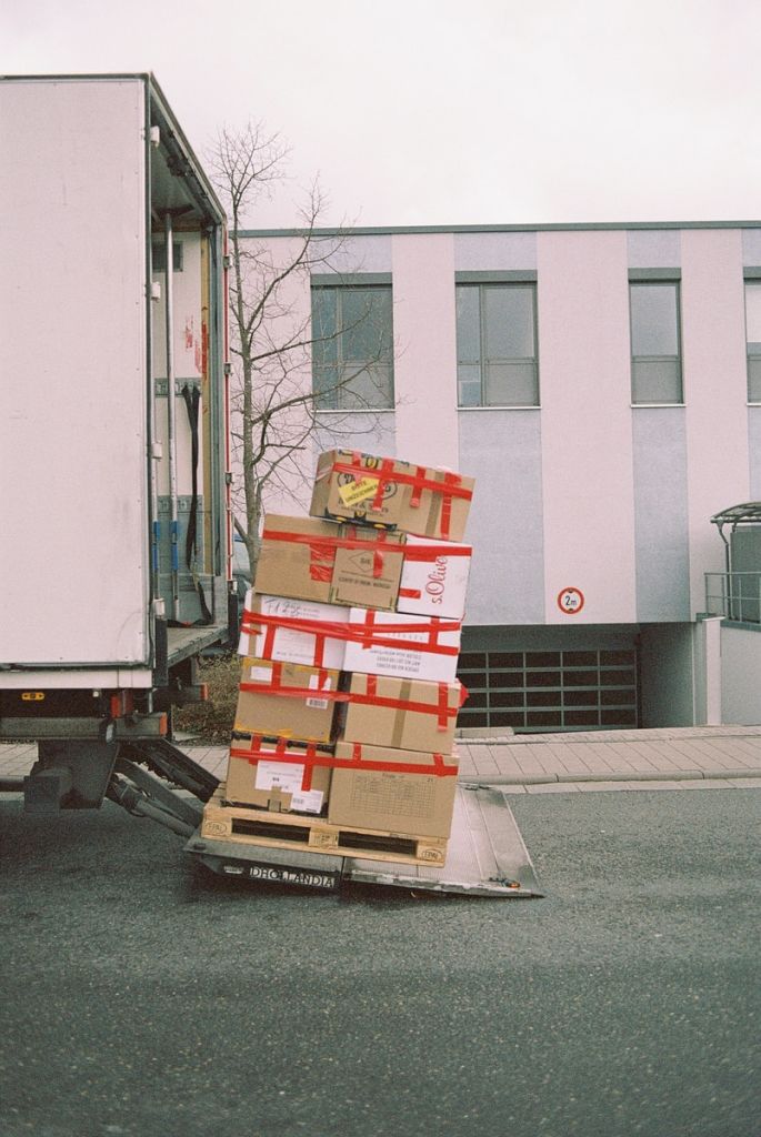 brown cardboard boxes on gray asphalt road