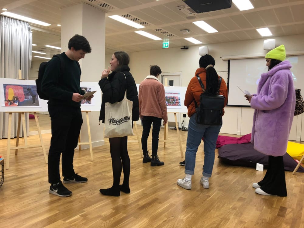 Students stand in Bush House exhibition room