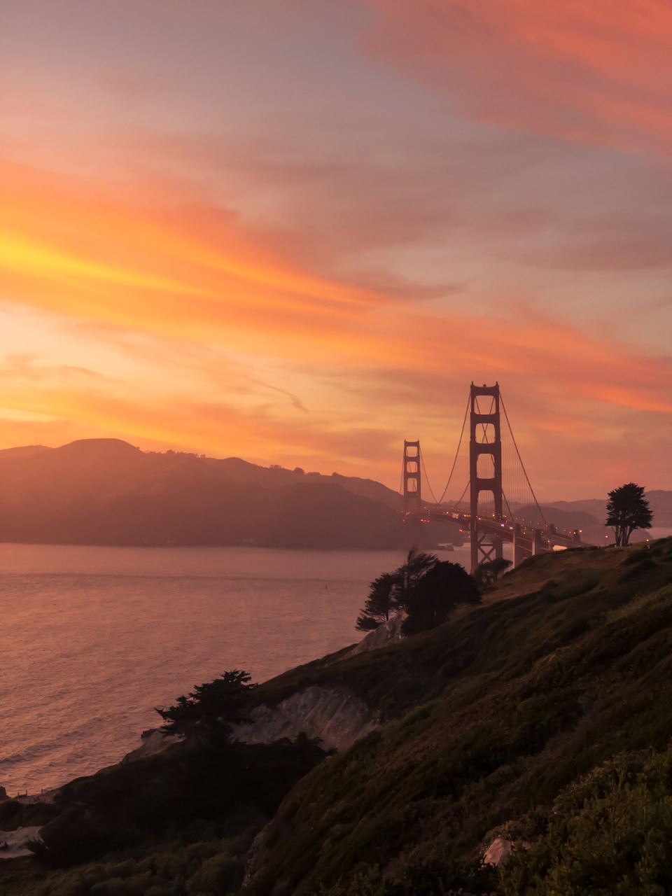 View of Golden Gate Bridge at sunset from the Presidio of San Francisco in San Francisco, California.