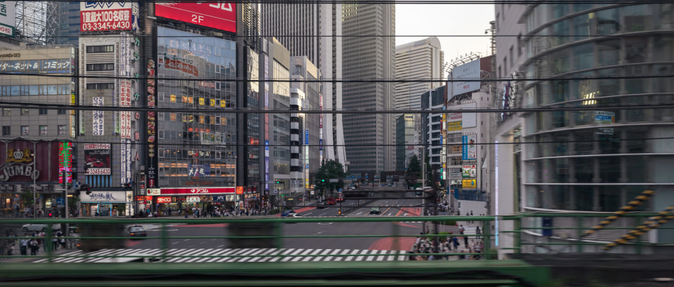 Nishi-Shinjuku cityscape viewed from a Yamanote Line train approaching Shinjuku station from the north in Tokyo, Japan.