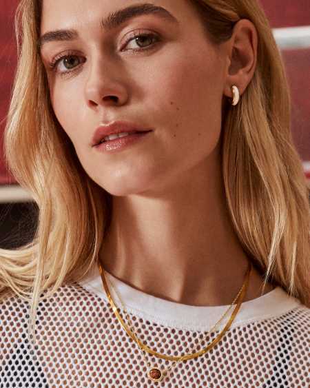 Ainsley Gold Huggie Earrings in White Enamel