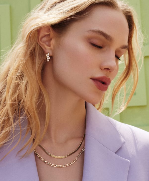 Model wearing multiple pieces of jewelry