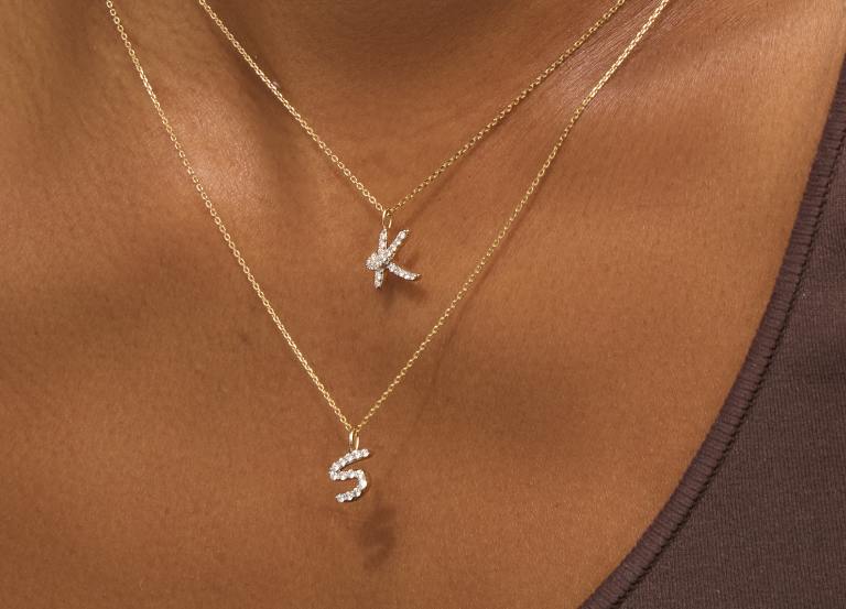 Image of model wearing diamond initial necklaces