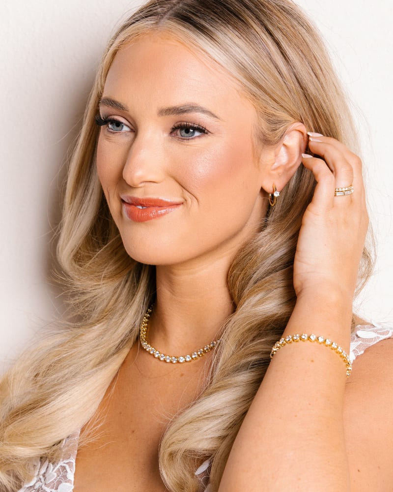 Jackie Gold Huggie Earrings in White Crystal image number 2