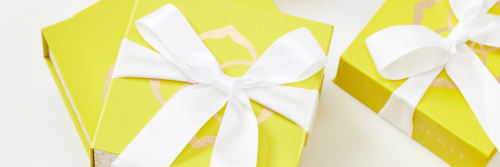 Image of yellow Kendra Scott gift boxes