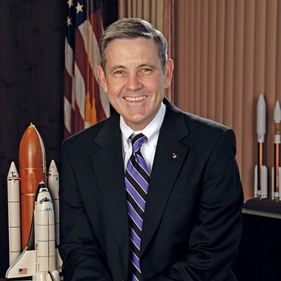 Headshot of Bob Cabana in front of a U.S. flag and space shuttle model