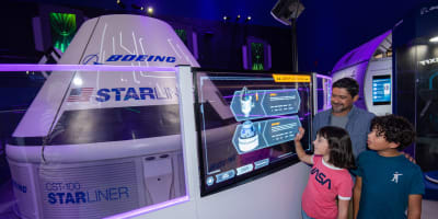 Father and 2 children viewing the starlink attraction