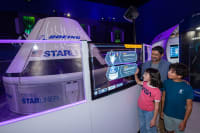 Father and 2 children viewing the starlink attraction