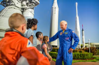 Astronaut talking to a group of children in the rocket garden