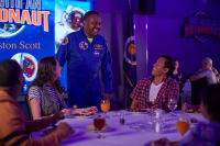 Astronaut talking to a group of visitors siting at a table during Chat With An Astronaut at Kennedy Space Center