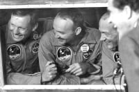 Astronauts inside of a quarantine capsule