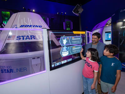Father and 2 children viewing the starlink attraction