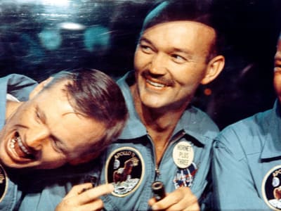 Three members of the Apollo 11 crew laughing