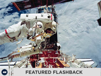 Astronauts servicing the space station in space