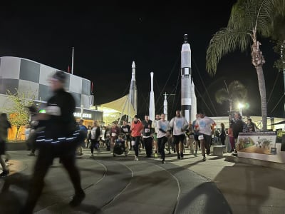 Runners of the Space Race run past the rocket garden