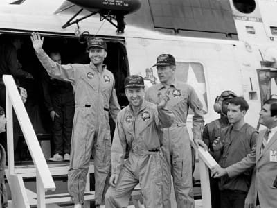 Apollo 13 crew returning from their mission and waving to the crowd
