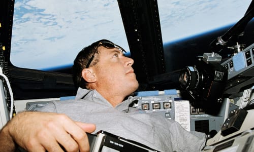 Baker looking at the Earth from space during STS-68 mission