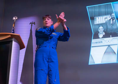 Female astronaut presenting at The Astronaut Encounter.