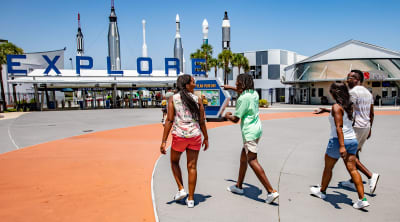 Family entering the front gate of the Kennedy Space Center Visitor Complex