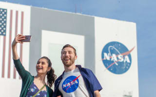 Couple taking a selfie in front of the NASA building
