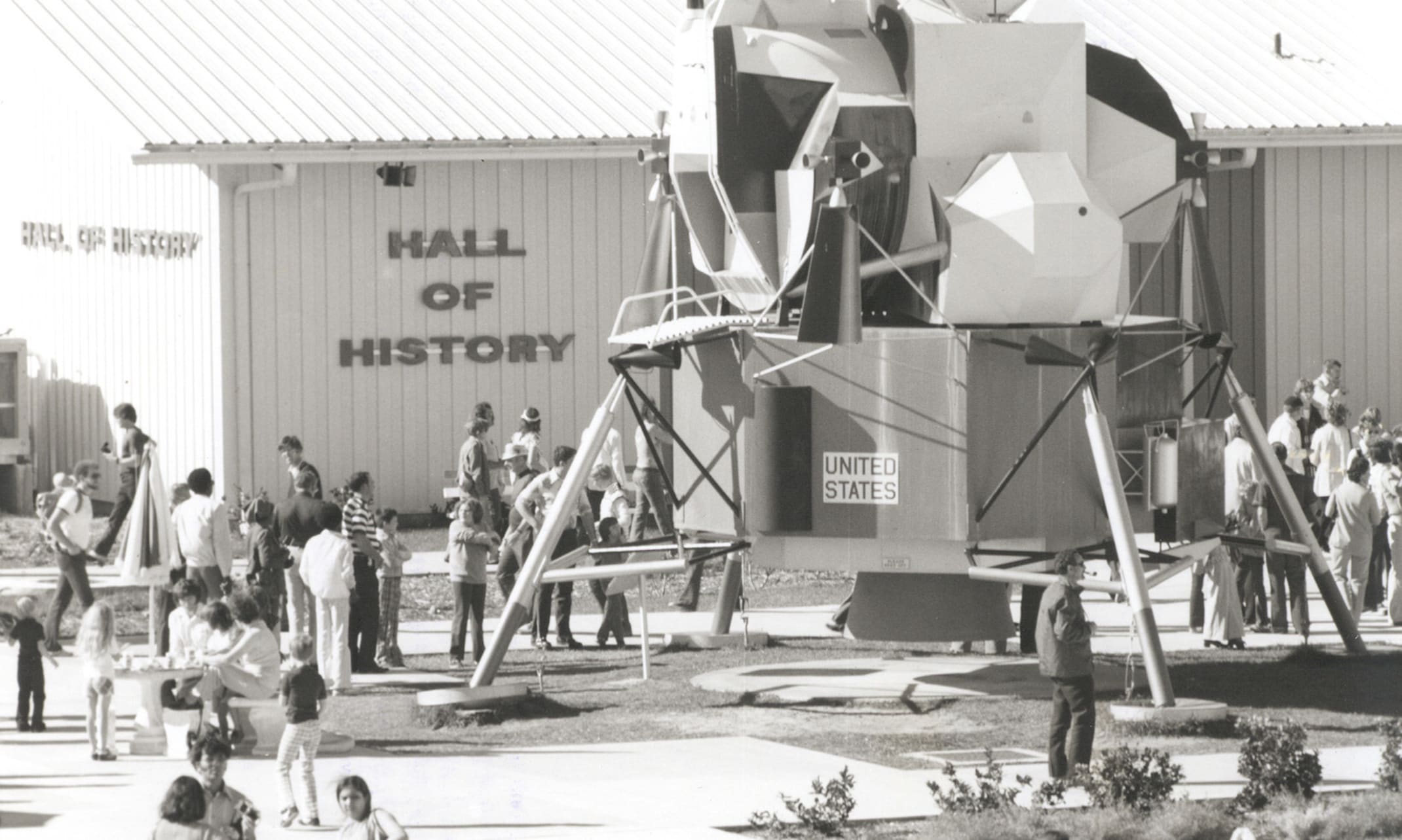 Guests are enjoying a popular outdoor display from the mid-to-late 1970s: a full-scale engineering mockup of an Apollo Lunar Module (LM).