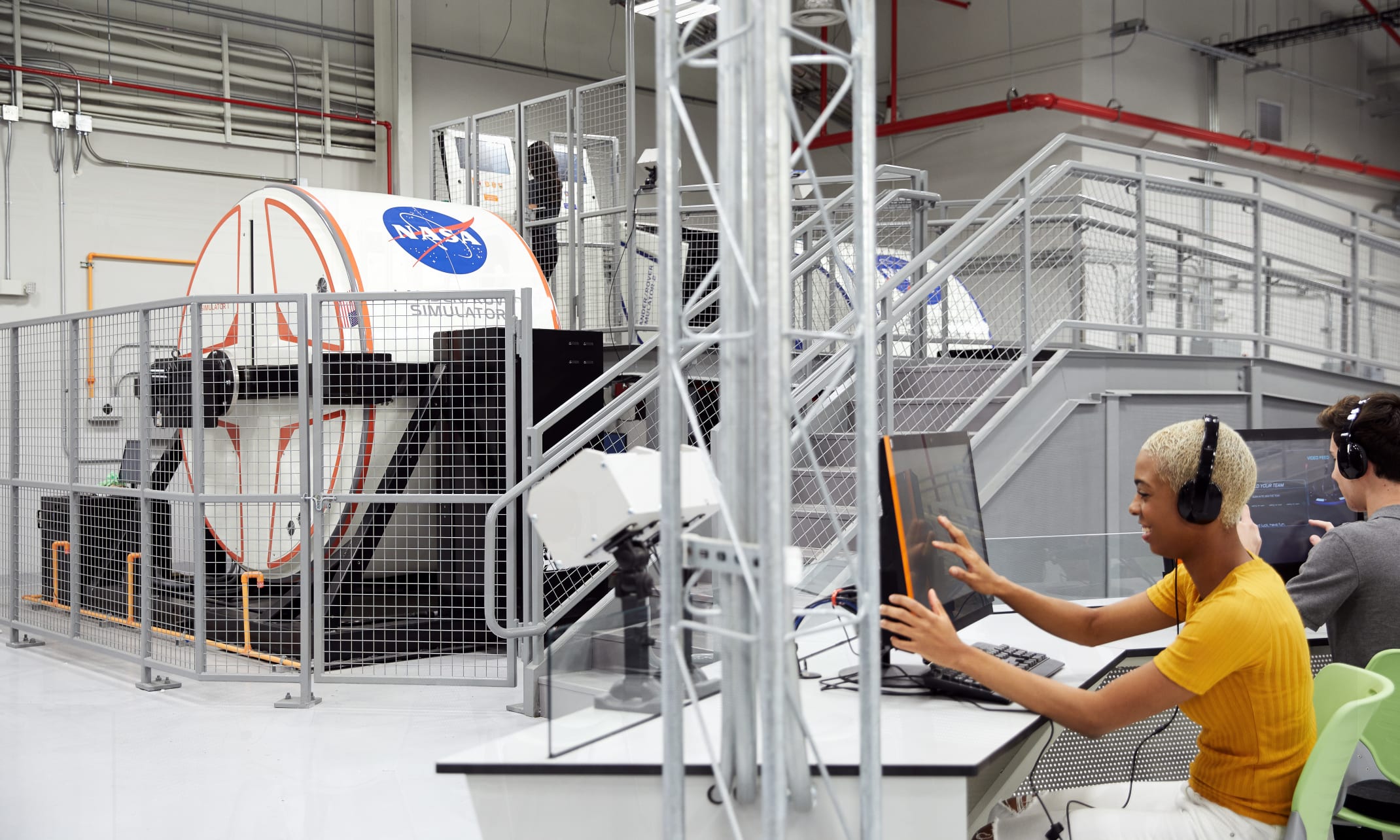 Student on computer participating in the full-motion simulator at the ATX center
